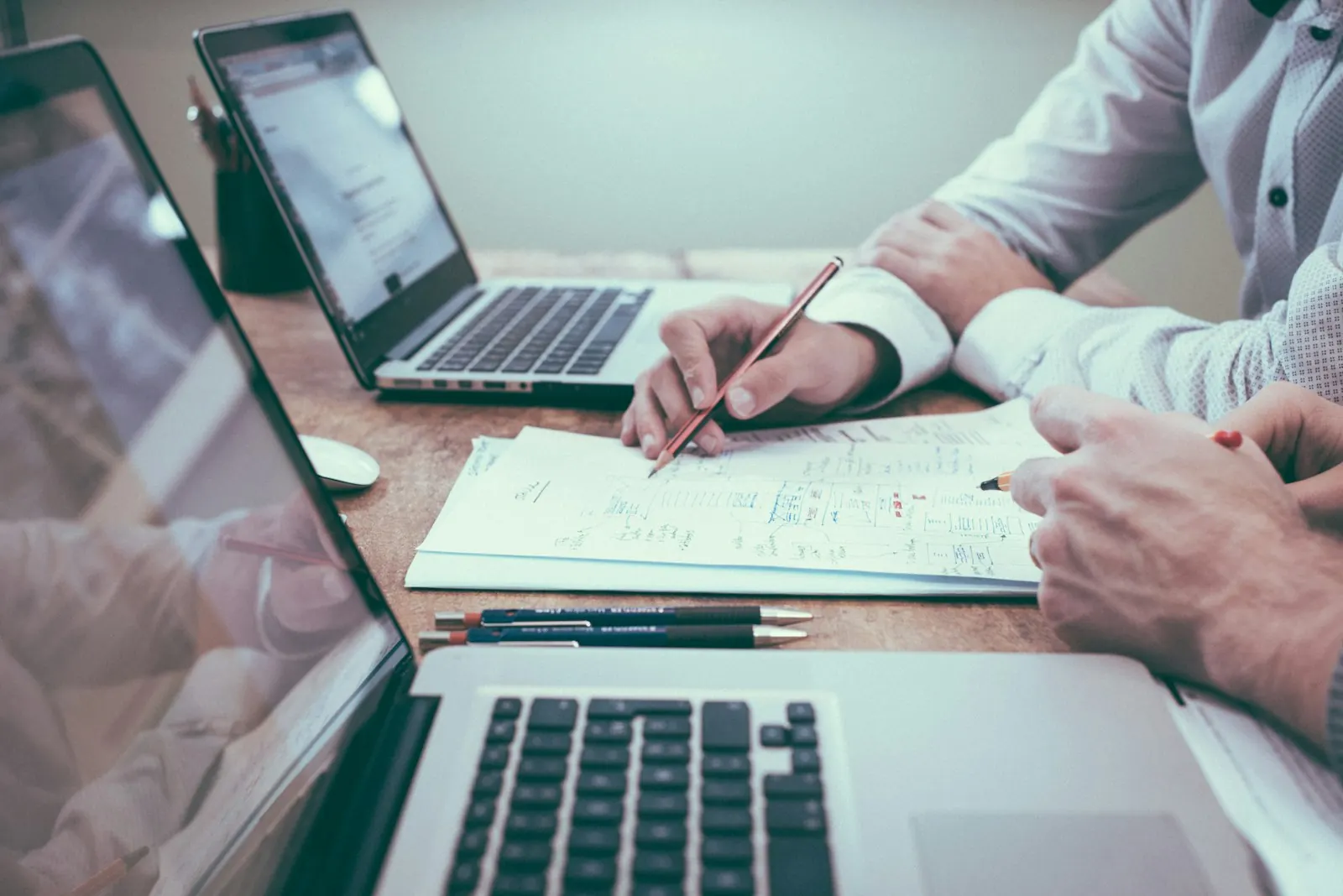 Advisors reviewing documents at a laptop