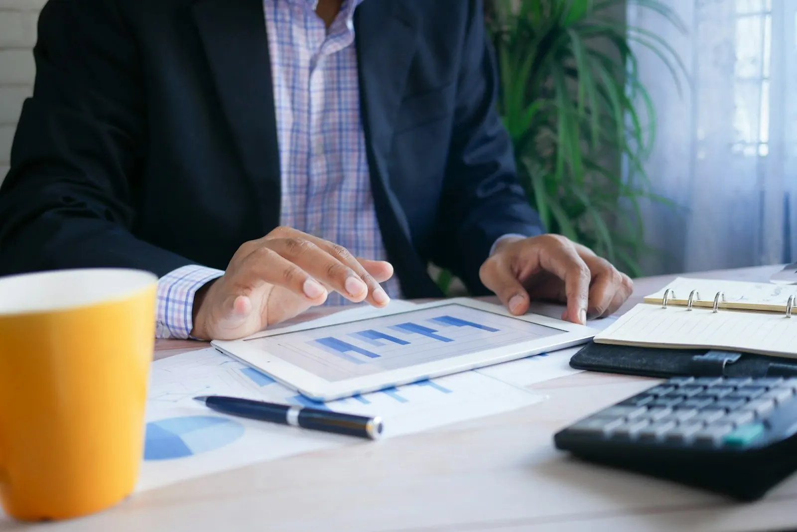 Finance professional reviewing reports on a tablet